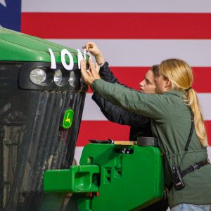 Staffers taping letters to a tractor